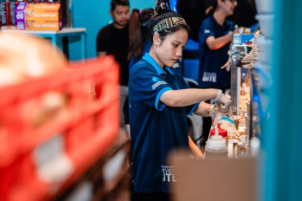 A staff preparing food at Bami Brickworks